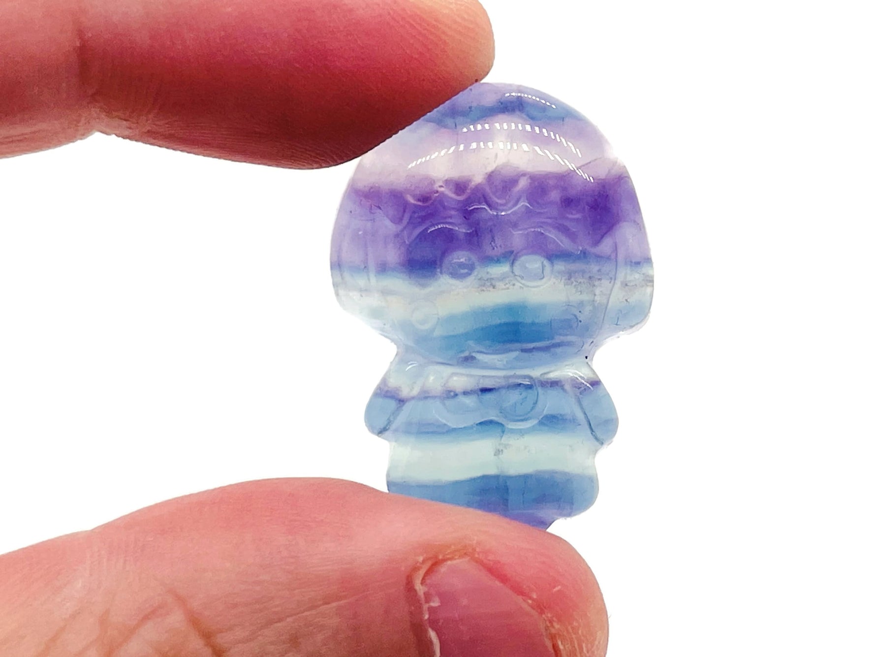 Fluorite girl kid carving gemstone by GemstoneGO, showcasing vibrant purple and green colors in a detailed hand-carved figure.