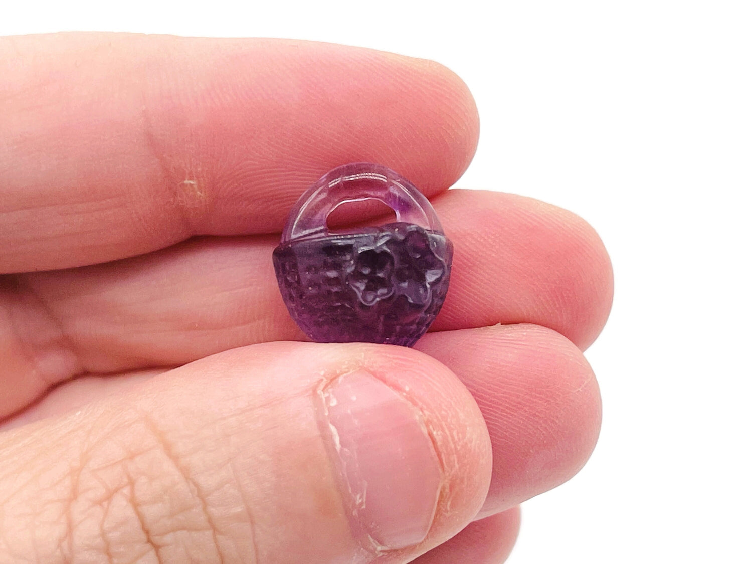 Colorful fluorite gemstone garden basket carving by GemstoneGO, showcasing intricate details and vibrant hues in a polished display.