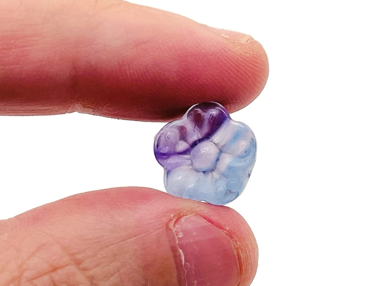 Small fluorite mini flower carving gemstone by GemstoneGO showing a vibrant purple and green floral design.