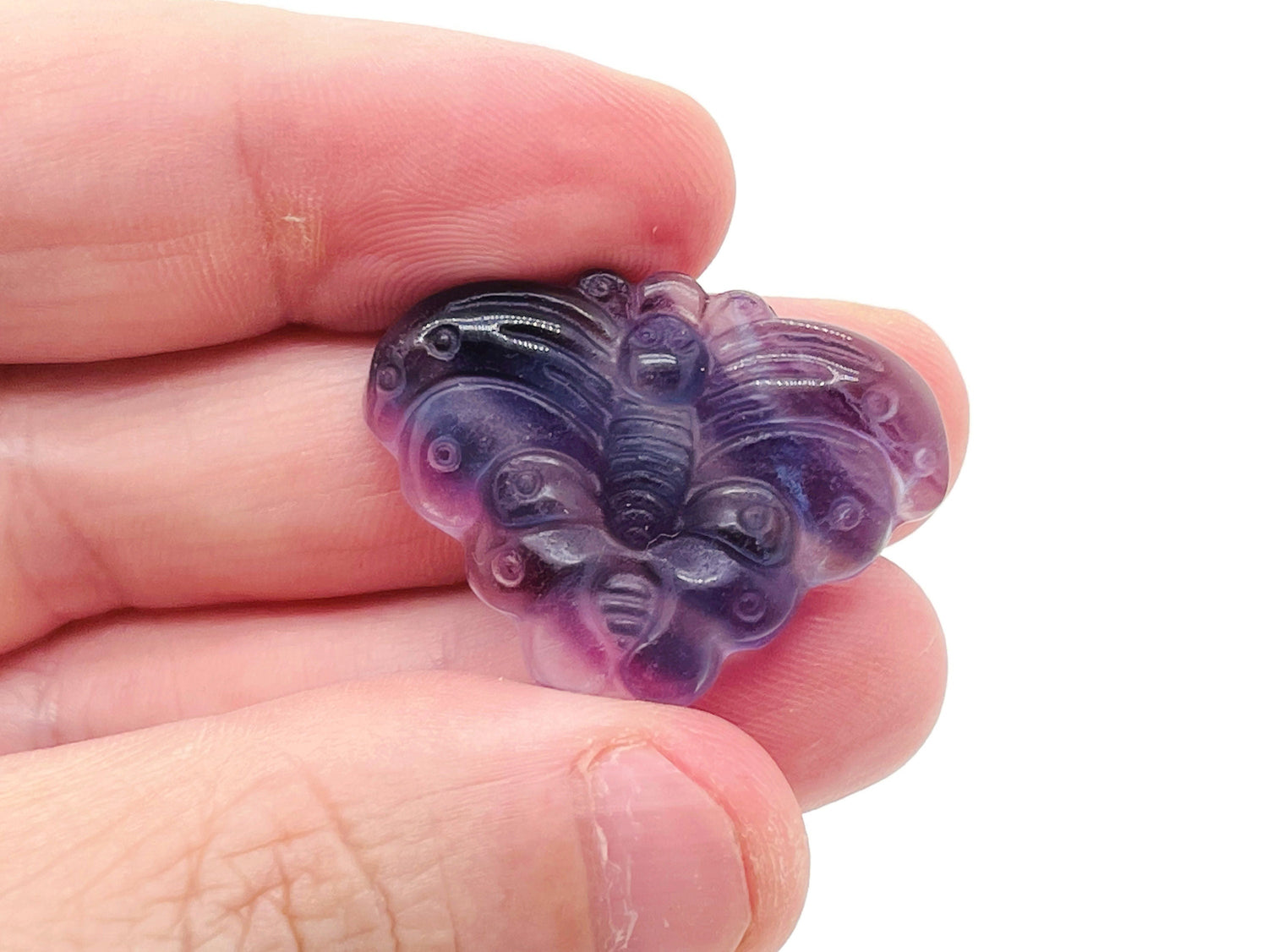 Fluorite butterfly carving gemstone by GemstoneGO, showing a colorful polished gemstone with intricate butterfly design.