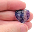 Polished fluorite heart gemstone carving from GemstoneGO, showcasing vibrant purple and green colors and smooth, detailed craftsmanship.