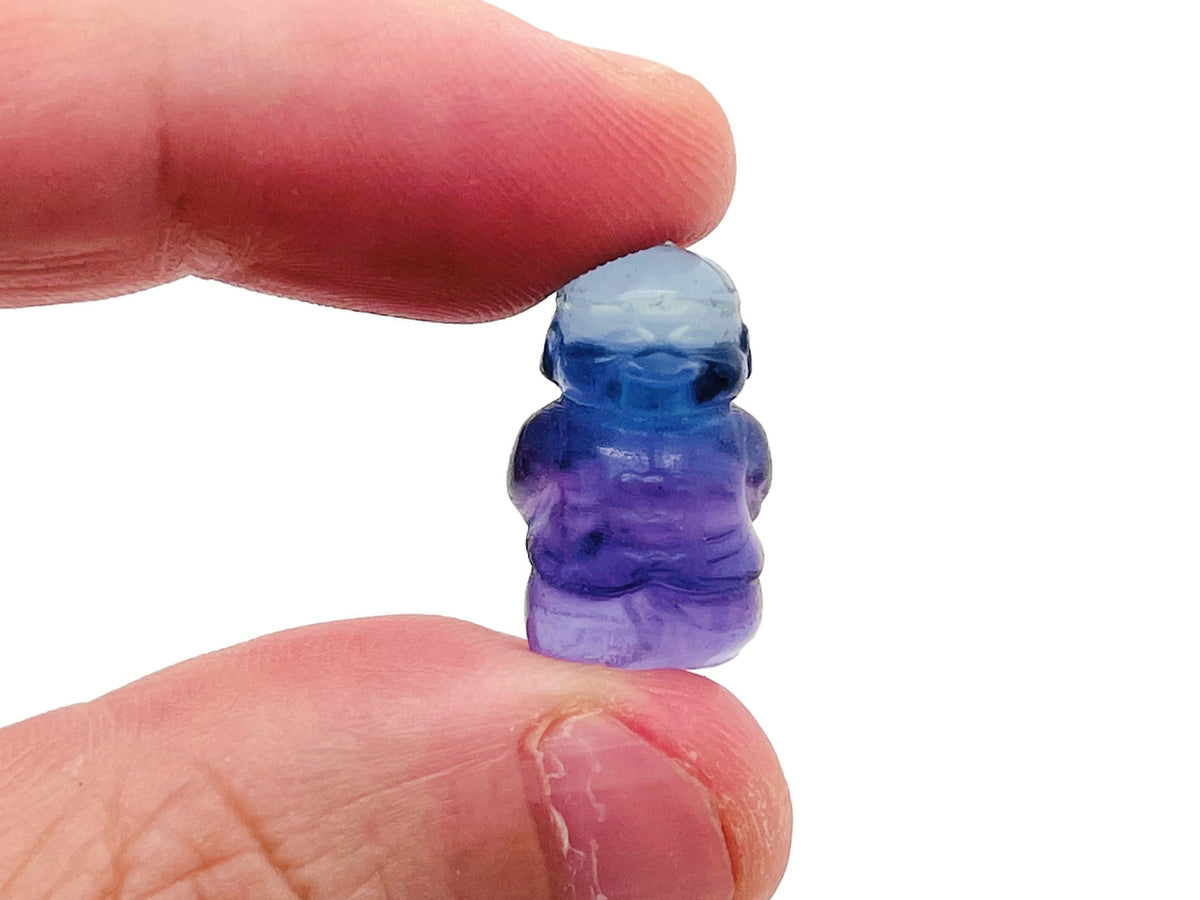 Small fluorite crystal carving gemstone from GemstoneGO, showcasing vibrant purple and green hues with intricate natural patterns.