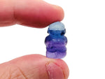 Small fluorite crystal carving gemstone from GemstoneGO, showcasing vibrant purple and green hues with intricate natural patterns.