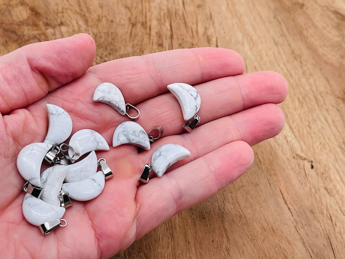 Howlite moon crystal pendant from GemstoneGO, showcasing a smooth, polished white gemstone with moon shape for jewelry making.