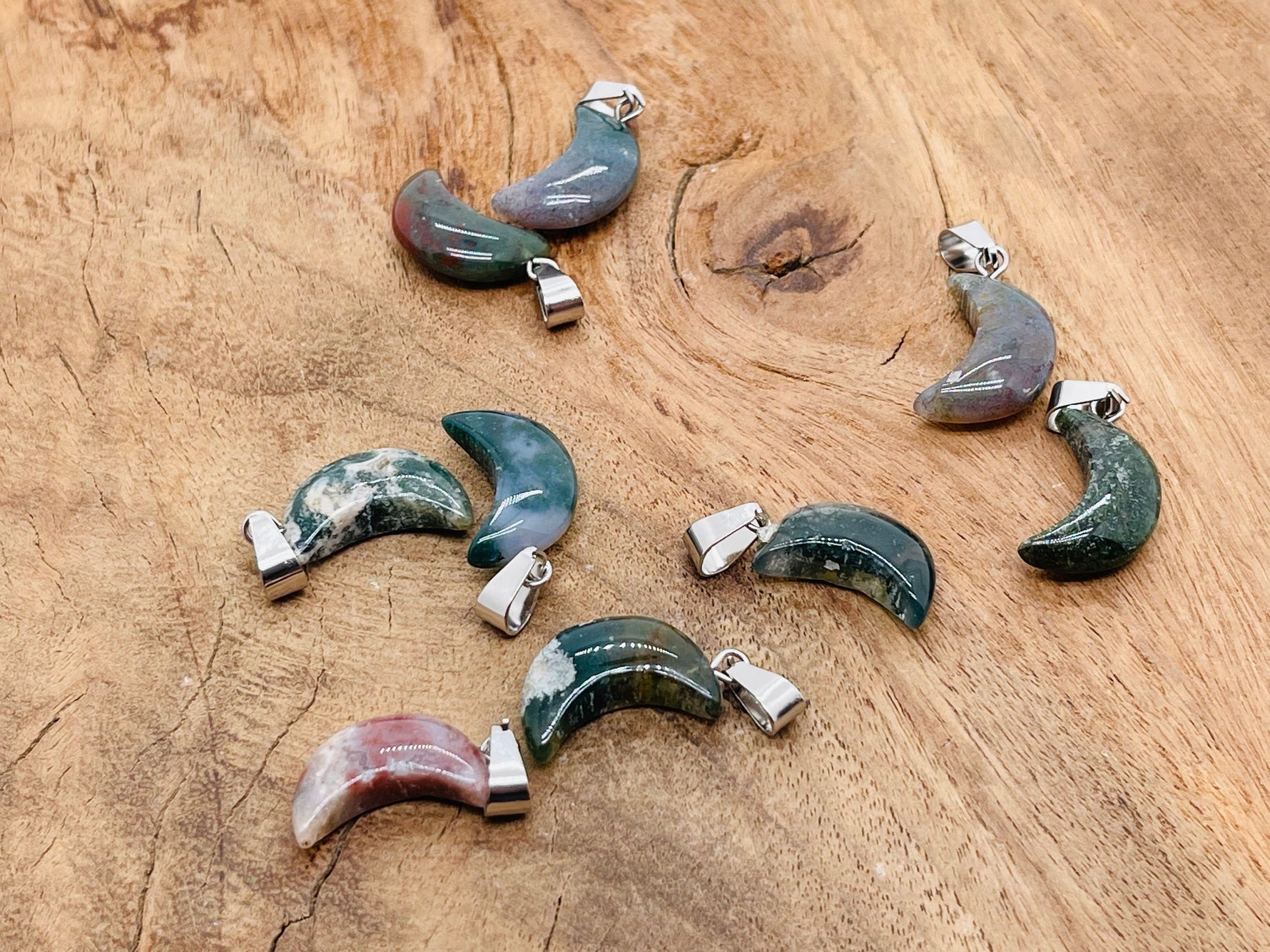 Moss agate crystal pendant from GemstoneGO, featuring a natural stone with green and brown moss-like patterns for jewelry making.