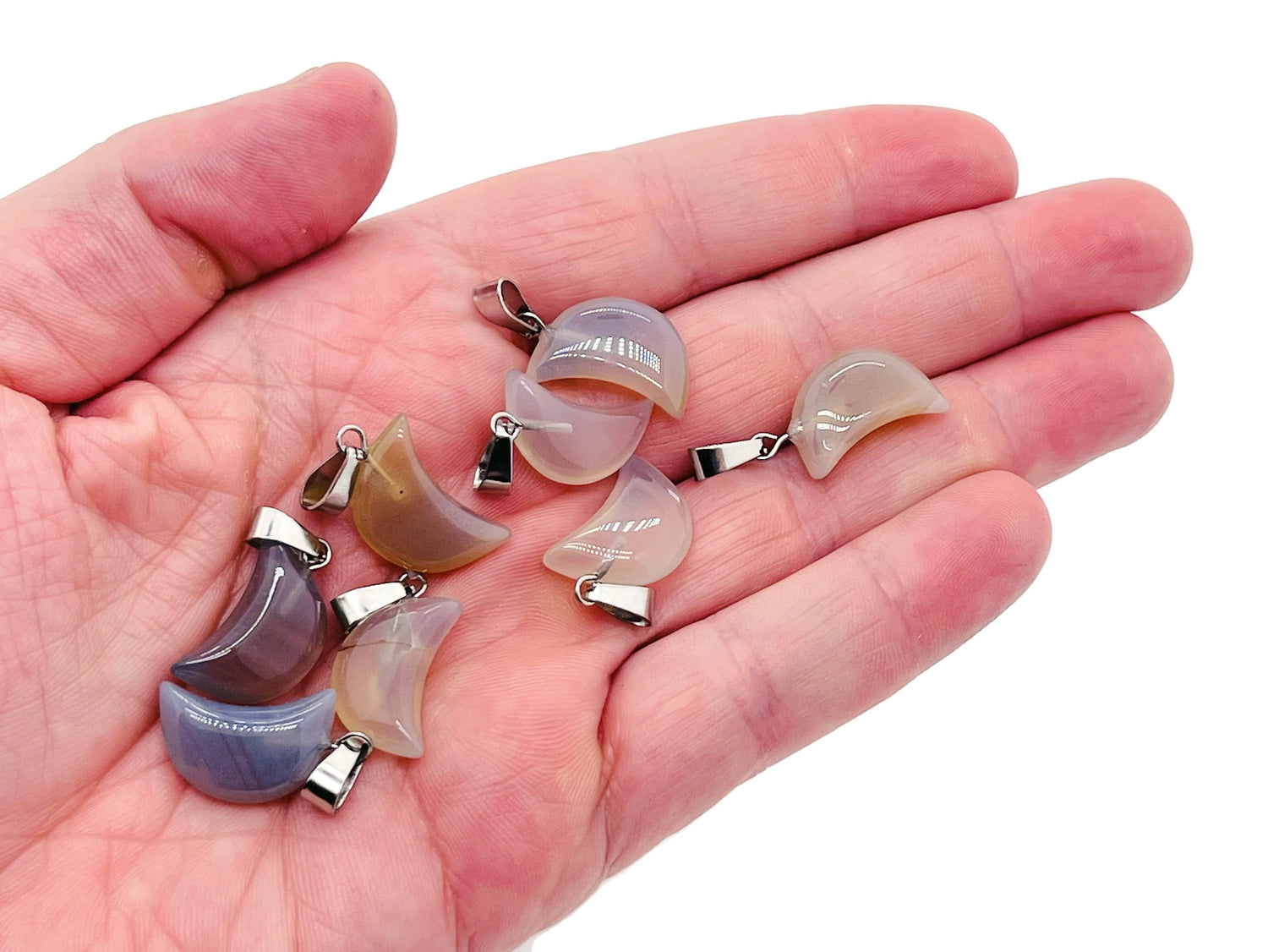 Grey agate moon crystal pendant from GemstoneGO, showcasing a polished, natural gemstone with a smooth crescent moon shape.