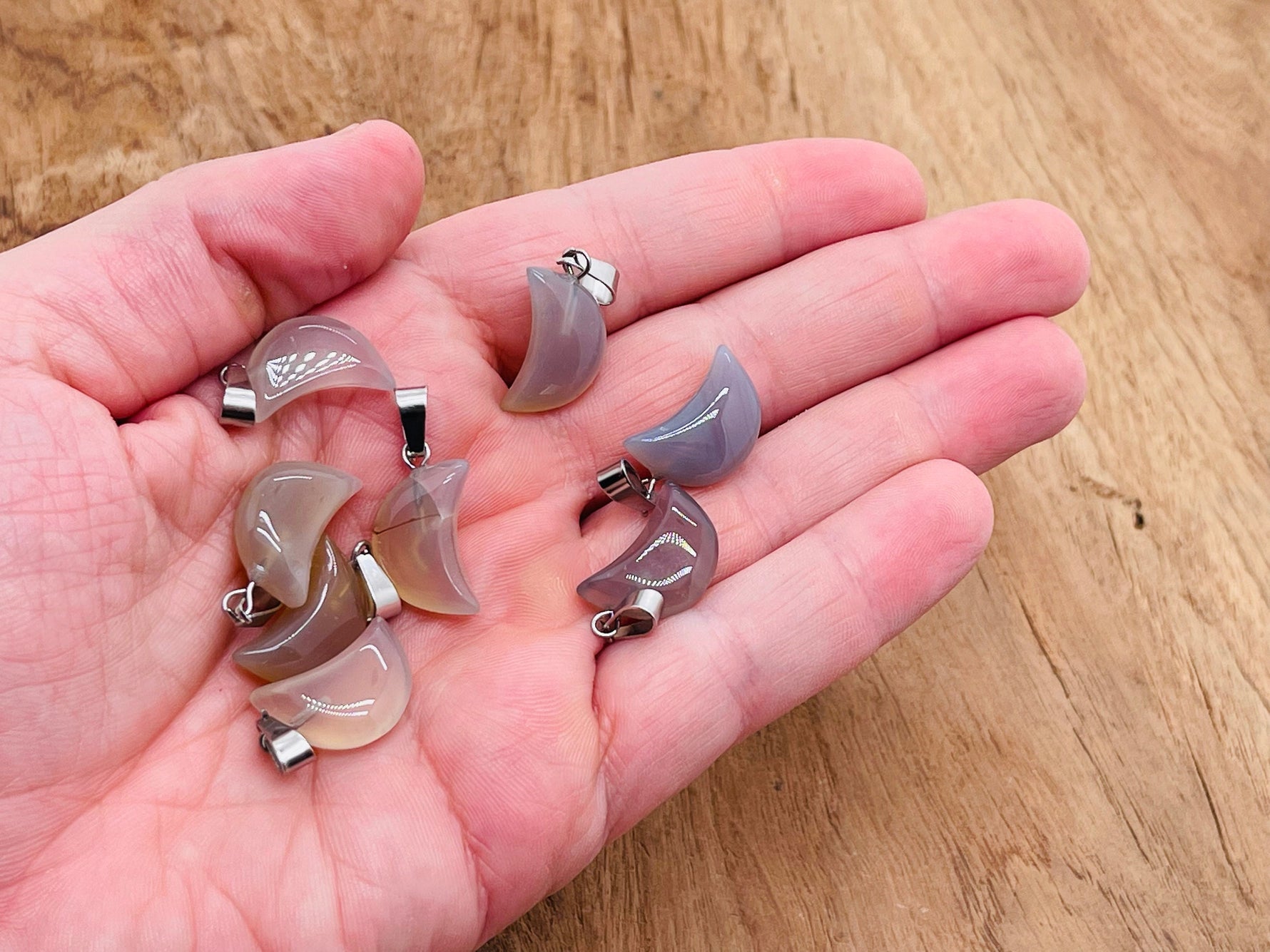 Grey agate moon crystal pendant from GemstoneGO, natural stone jewelry making supply with polished round shape and moon motif.