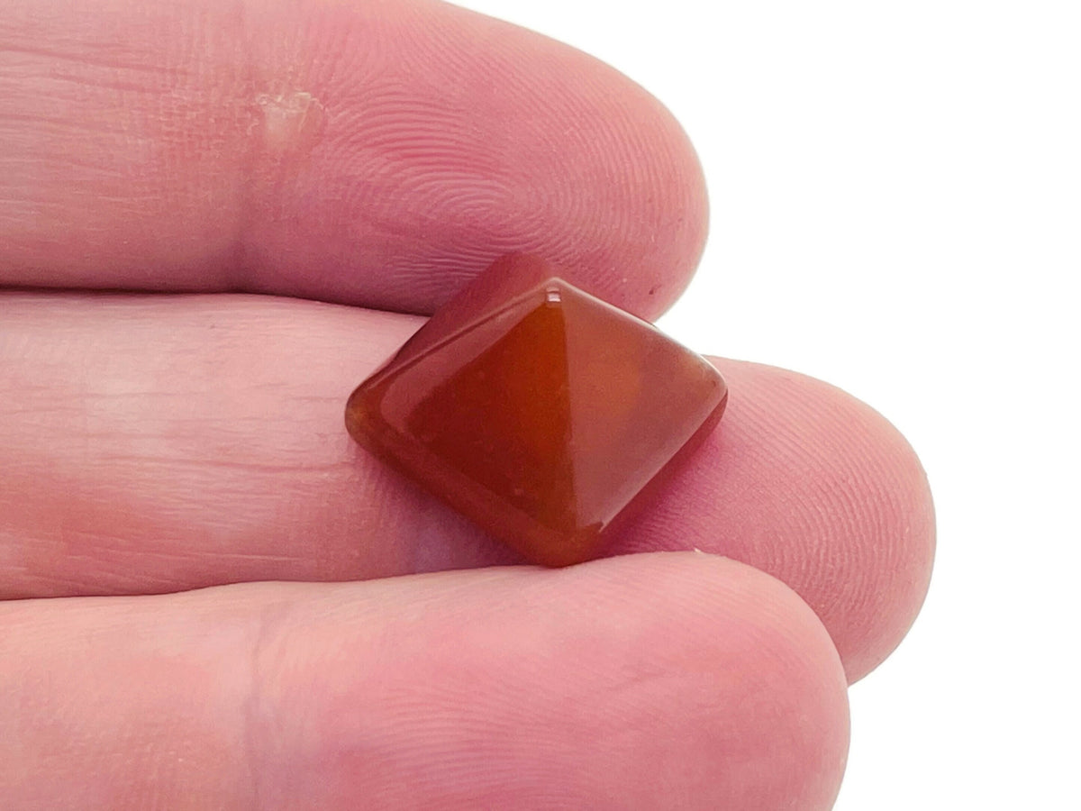 14mm Carnelian pyramid gemstone carving from GemstoneGO, showcasing vibrant orange-red color and detailed pyramid shape.