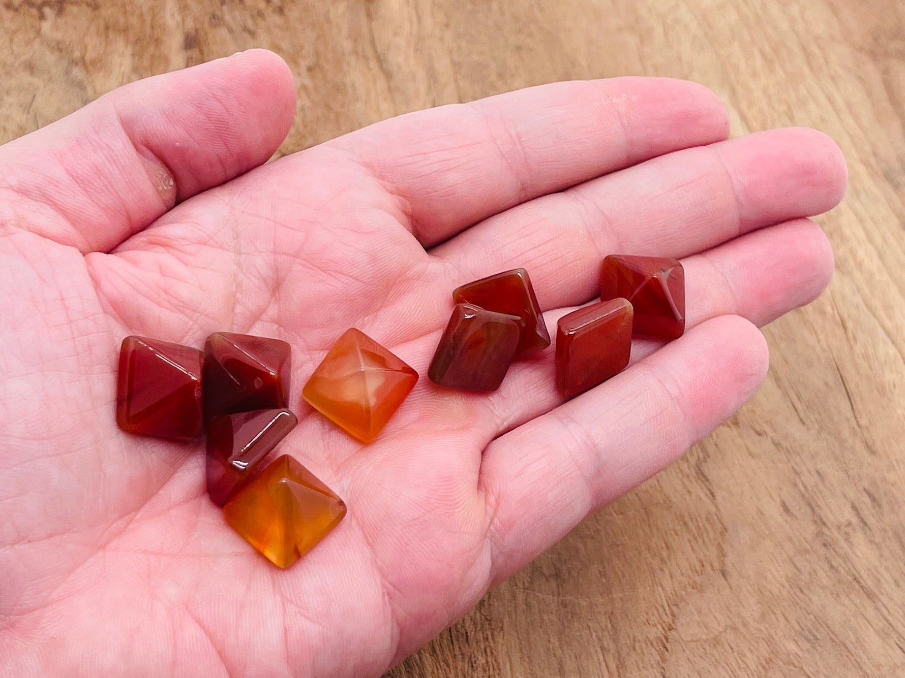 14mm Carnelian pyramid gemstone carving from GemstoneGO, showcasing vibrant orange color and smooth pyramid shape.