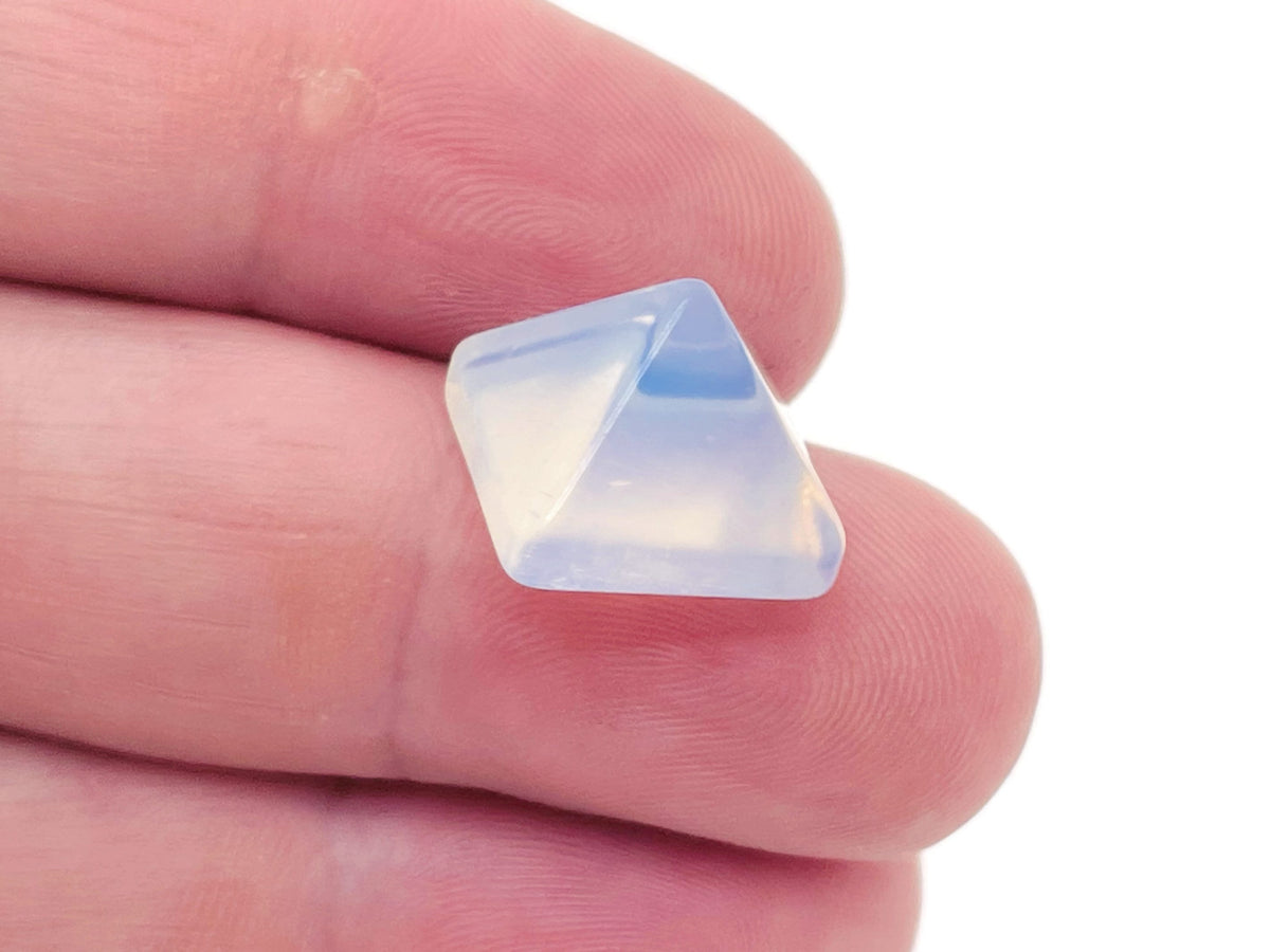 Opalite pyramid gemstone carving, 14mm, from GemstoneGO, featuring smooth, translucent white and blue hues in a carved pyramid shape.