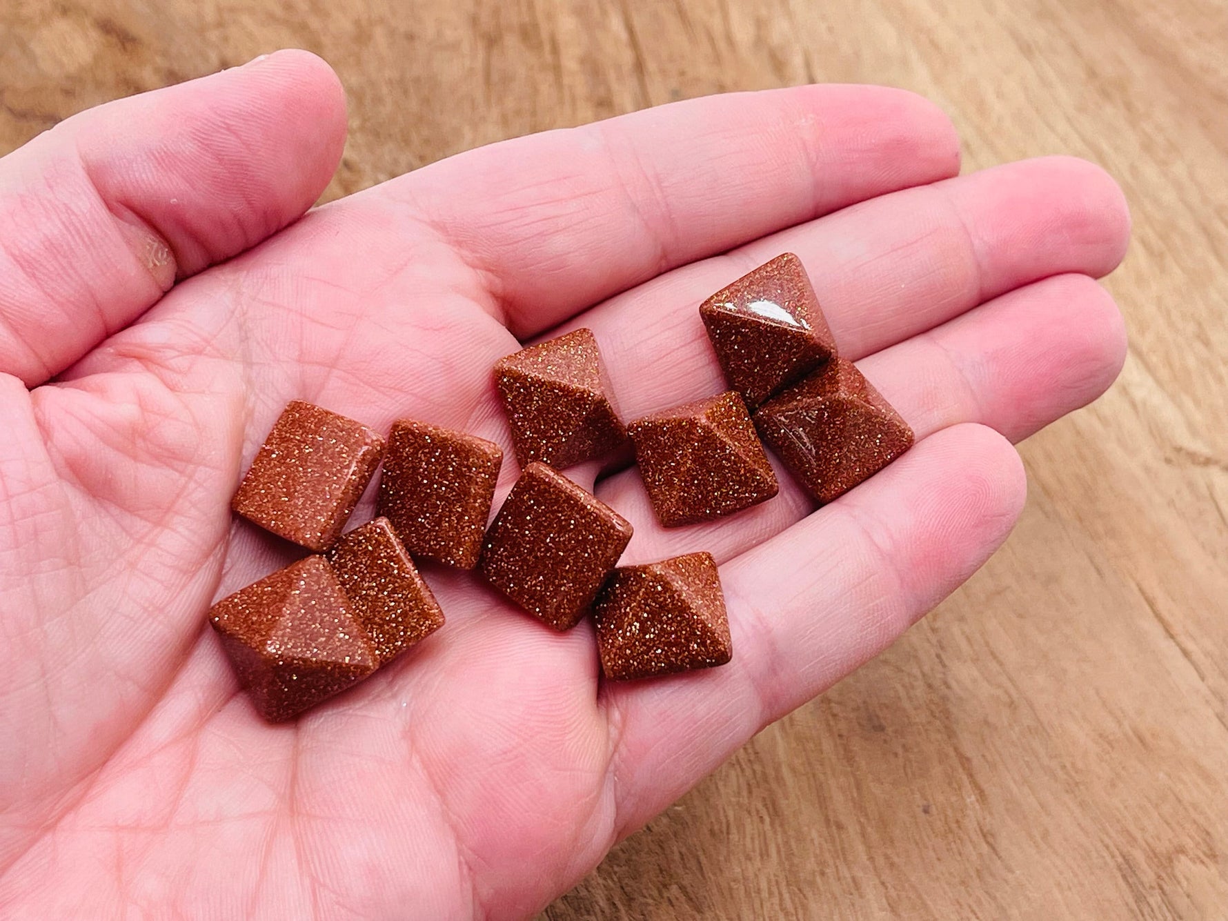 14mm Goldstone pyramid gemstone carving by GemstoneGO, showcasing a rich, sparkling brown and gold-colored pyramid-shaped stone.