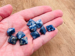 Blue Spot Jasper pyramid carving gemstone, 14mm, from GemstoneGO, showcasing a polished blue and black patterned mineral sculpture.