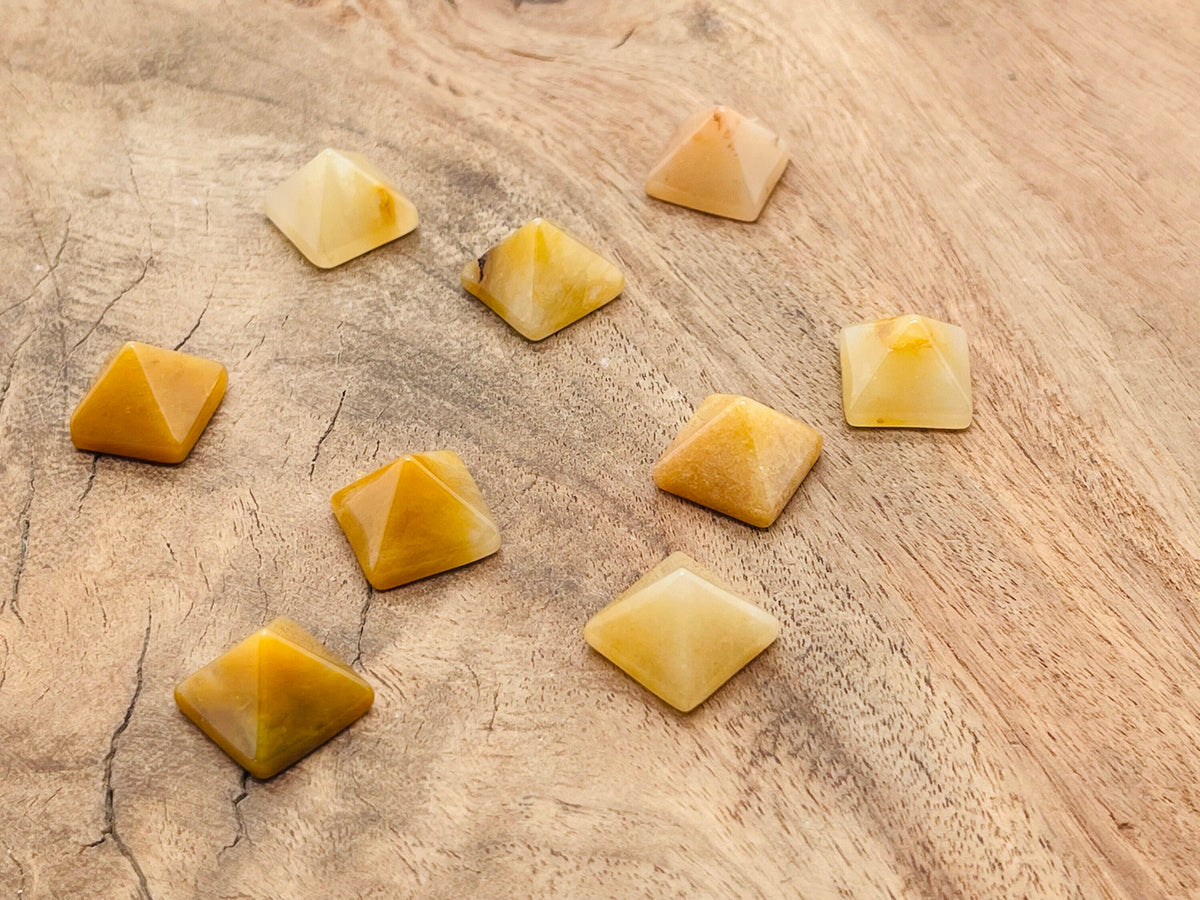 Yellow jade pyramid gemstone carving, 14mm, from GemstoneGO, showing detailed yellow jade pyramid with smooth polished surface.
