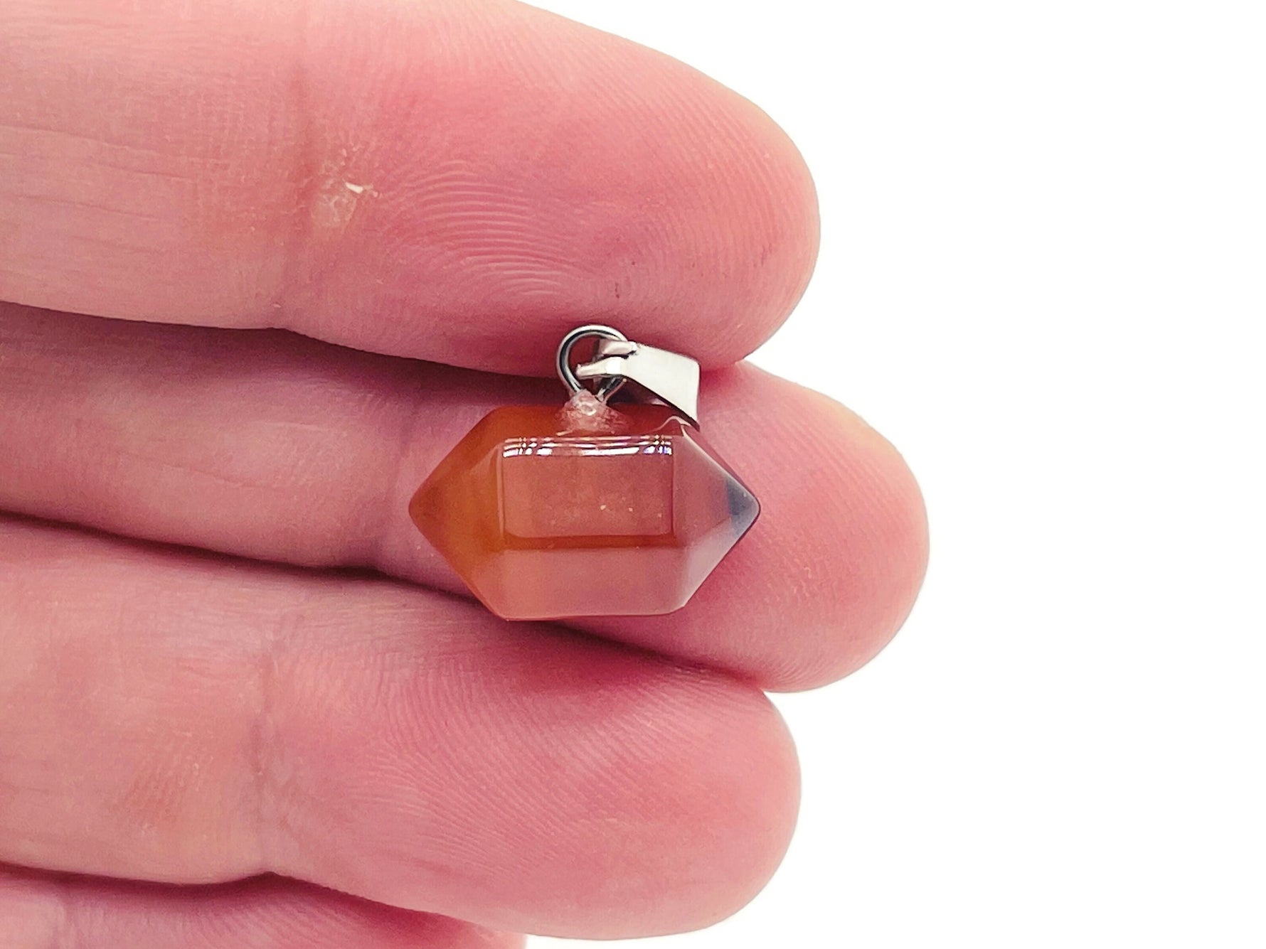 Carnelian point crystal pendant from GemstoneGO, featuring a vibrant orange-red gemstone for jewelry making supplies.