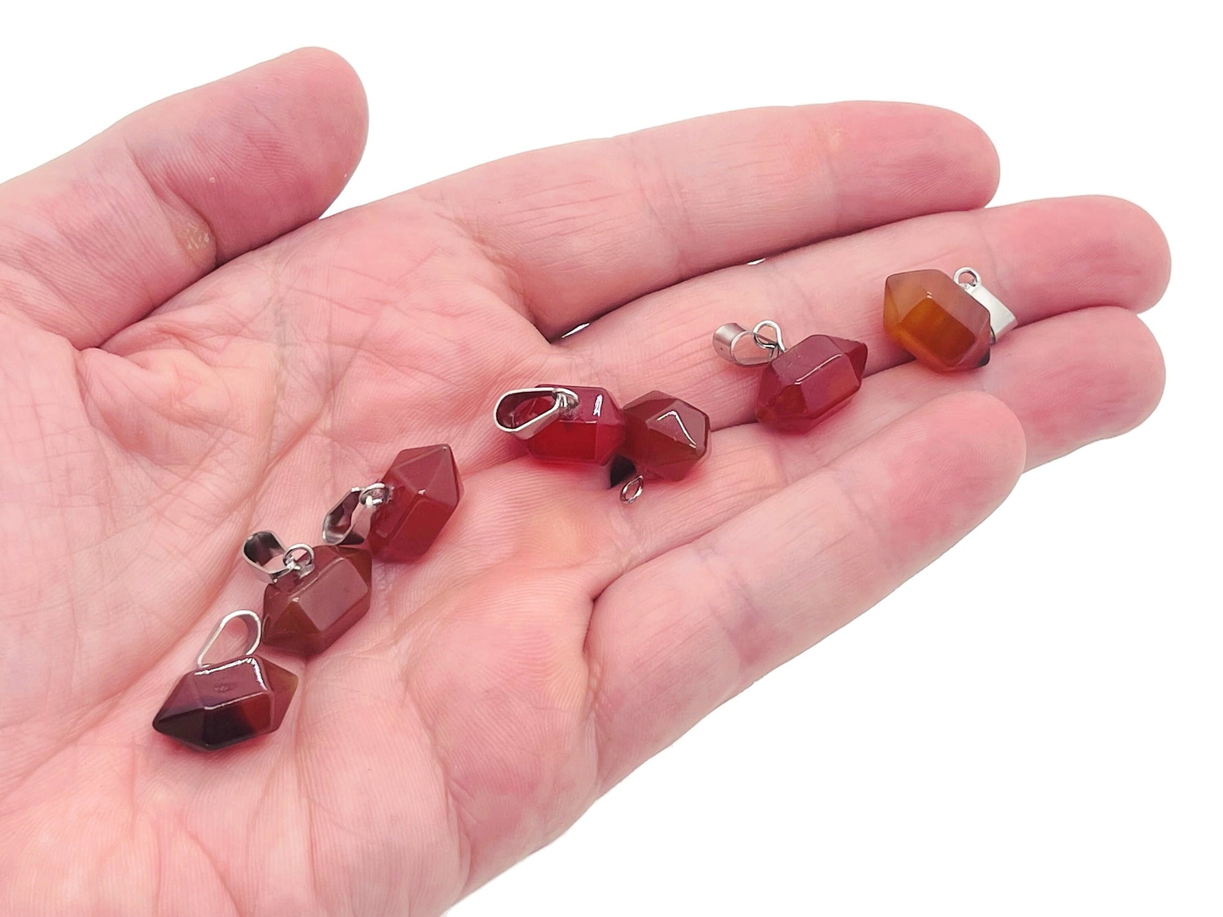 Carnelian point crystal pendant from GemstoneGO, showcasing vibrant orange gemstone for jewelry making and craft projects.