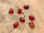 Carnelian point crystal pendant from GemstoneGO, showcasing a vibrant orange gemstone for jewelry making supplies.