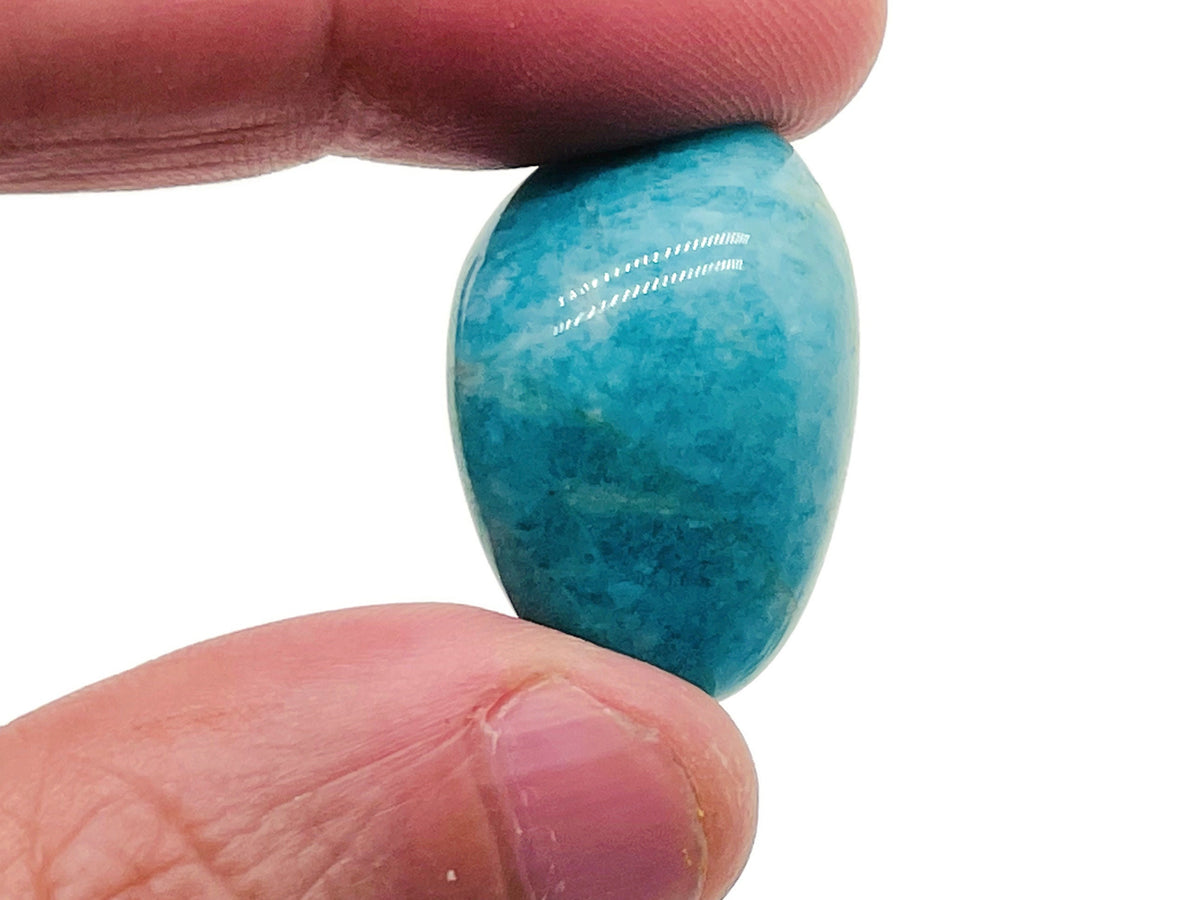 Amazonite tumbled stone by GemstoneGO, smooth blue-green gemstone with natural marbling, used for jewelry or healing practices.