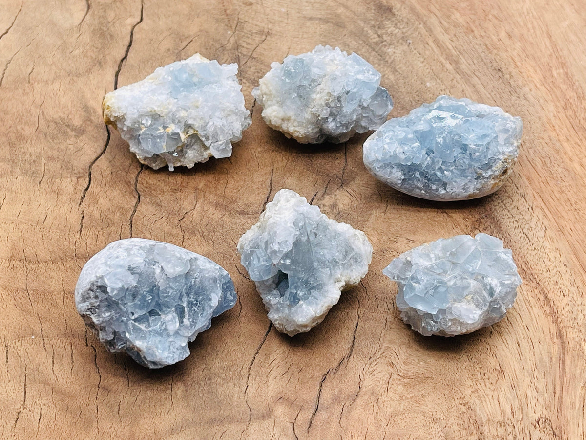 Raw celestite gemstone cluster from GemstoneGO, showcasing blue crystalline formations on a natural mineral base.