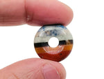 7 Chakra Crystal Donut Pi Stone from GemstoneGO, 20mm, featuring vibrant multicolored gemstones and a smooth donut shape.