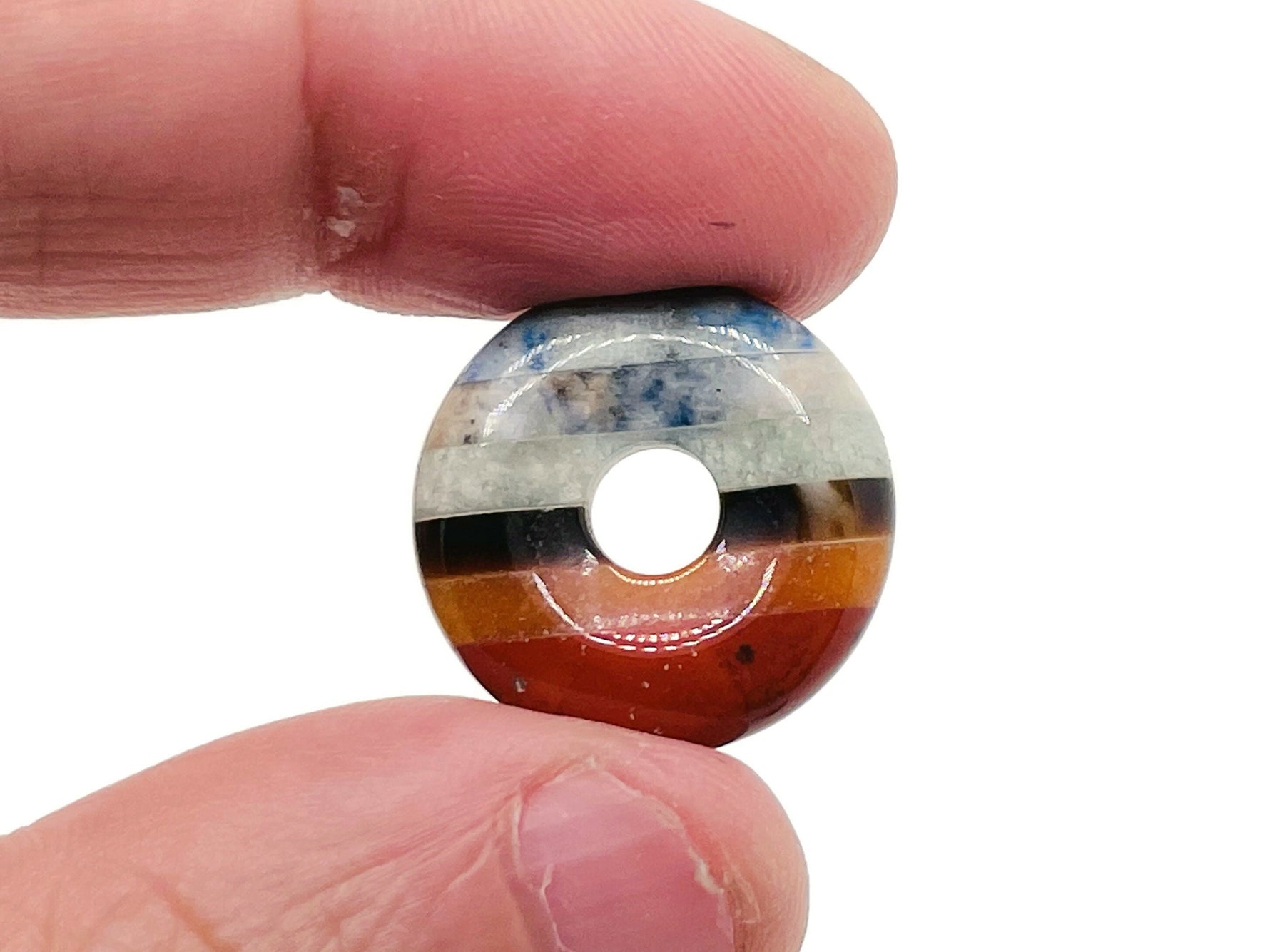 7 Chakra Crystal Donut Pi Stone from GemstoneGO, 20mm, featuring vibrant multicolored gemstones and a smooth donut shape.
