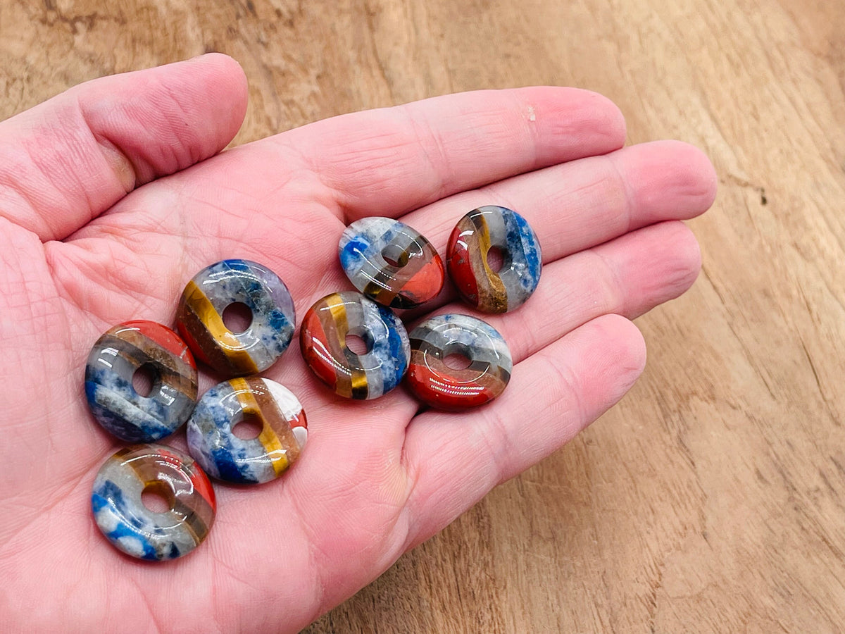 7 Chakra crystal donut pendant with pi stone, 20mm gemstone featuring vibrant chakra colors and intricate detailing.