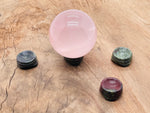 Dragon Blood Jasper crystal sphere on a carved gemstone stand, perfect for home decor and decorative displays.