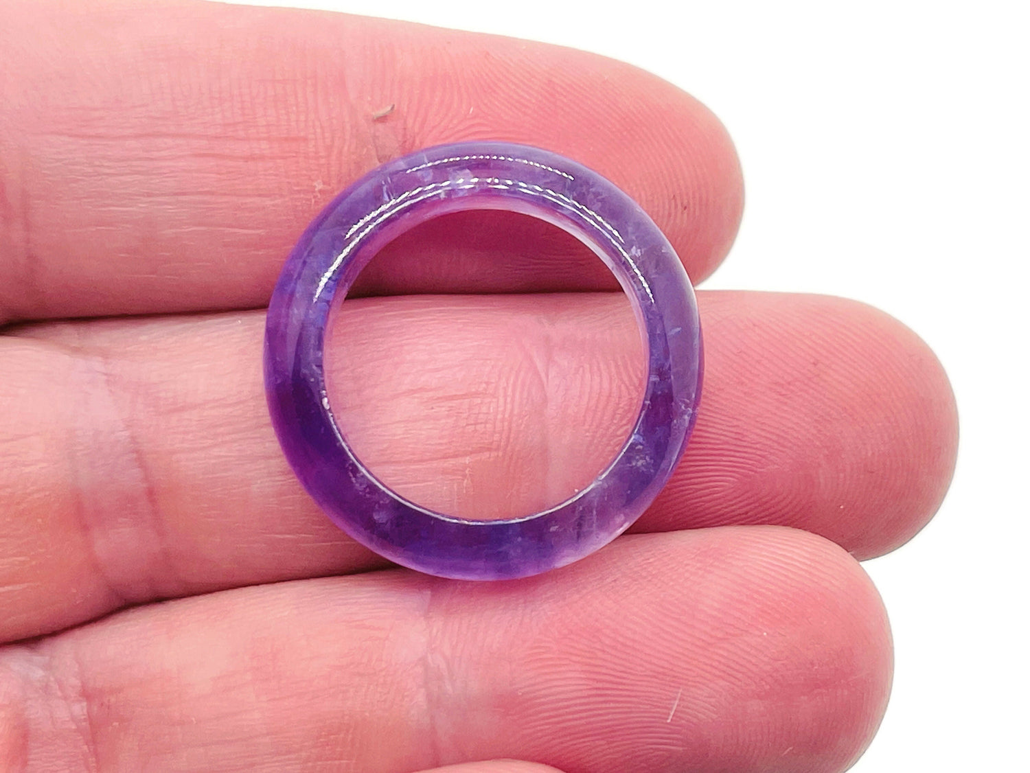 Amethyst crystal ring by GemstoneGO featuring a large purple gemstone set in a silver band.
