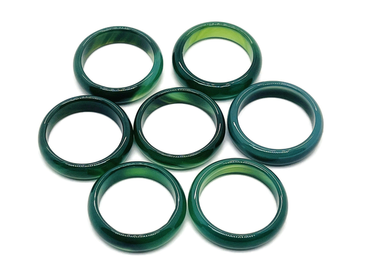 Green agate crystal ring with silver band from GemstoneGO, showcasing a polished green agate stone in a detailed jewelry setting.