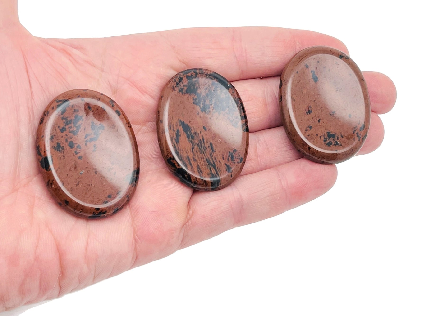 Mahogany Obsidian worry stone from GemstoneGO, smooth 4.5x3.5cm crystal for soothing stress relief and meditation.