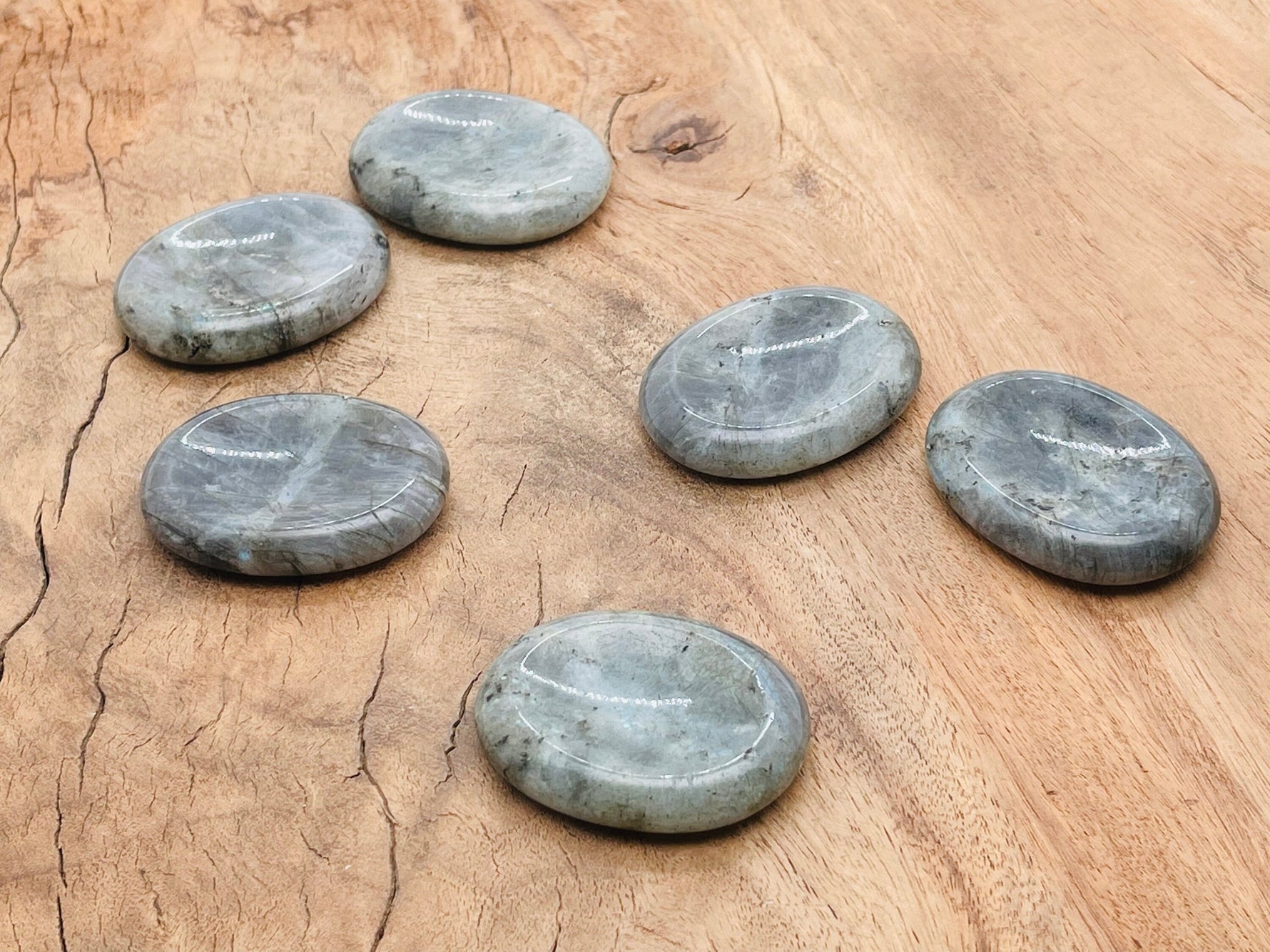 Labradorite worry stone from GemstoneGO, 4.5x3.5cm, featuring iridescent blue and green hues, used for soothing crystal meditation.