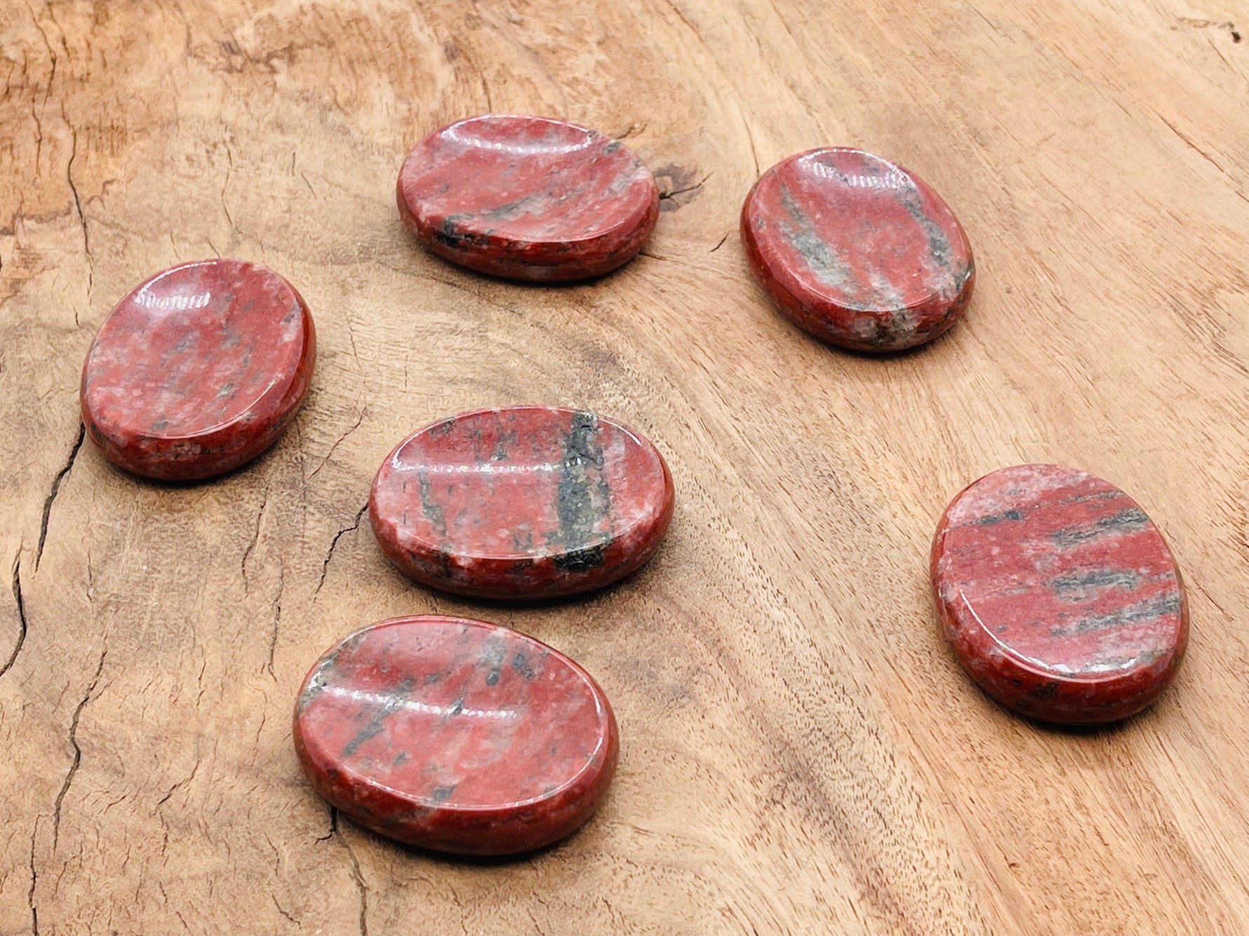 Red sesame jasper worry stone with smooth surface, measuring 4.5x3.5cm, featuring vibrant red and earthy tones from GemstoneGO.