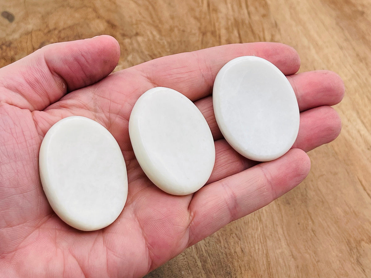 White jade worry stone from GemstoneGO, smooth 4.5x3.5cm crystal for stress relief and calming use.