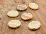 Yellow calcite worry stone from GemstoneGO, 4.5x3.5cm, smooth polished crystal for stress relief and calming energy.