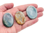 Moss agate worry stone from GemstoneGO, 4.5x3.5cm soothing crystal with natural green and brown moss patterns, smooth polished surface.
