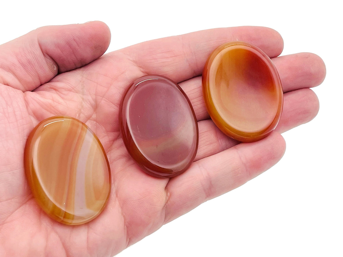 Carnelian worry stone from GemstoneGO, 4.5x3.5cm, smooth polished crystal for stress relief and calming in hand.