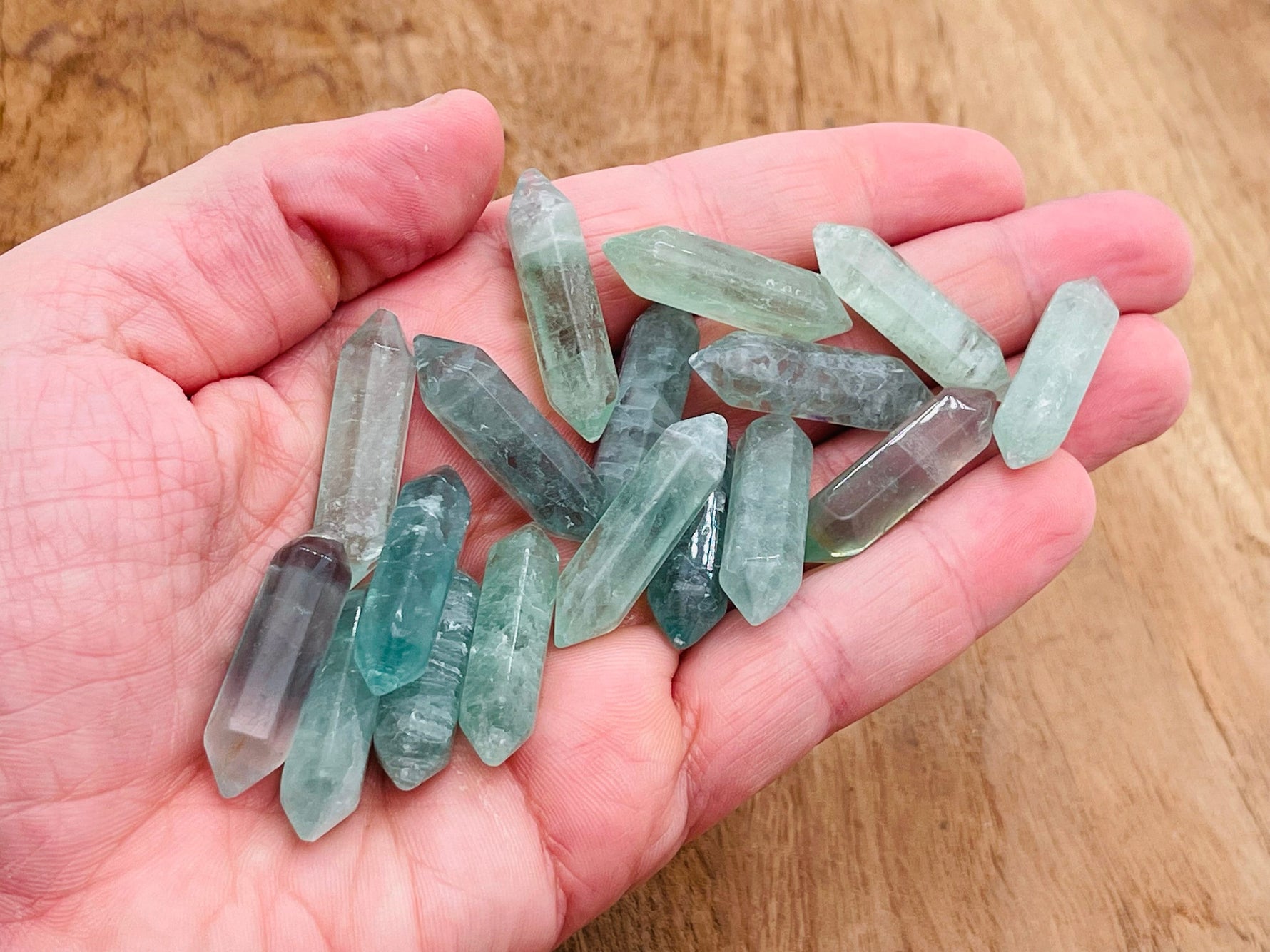 Green fluorite terminated carved point gemstone, 33mm, with natural crystal formations and smooth polished facets.