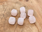 Handmade rose quartz crystal incense holder with carved design, designed for incense sticks and decorative gemstone display.