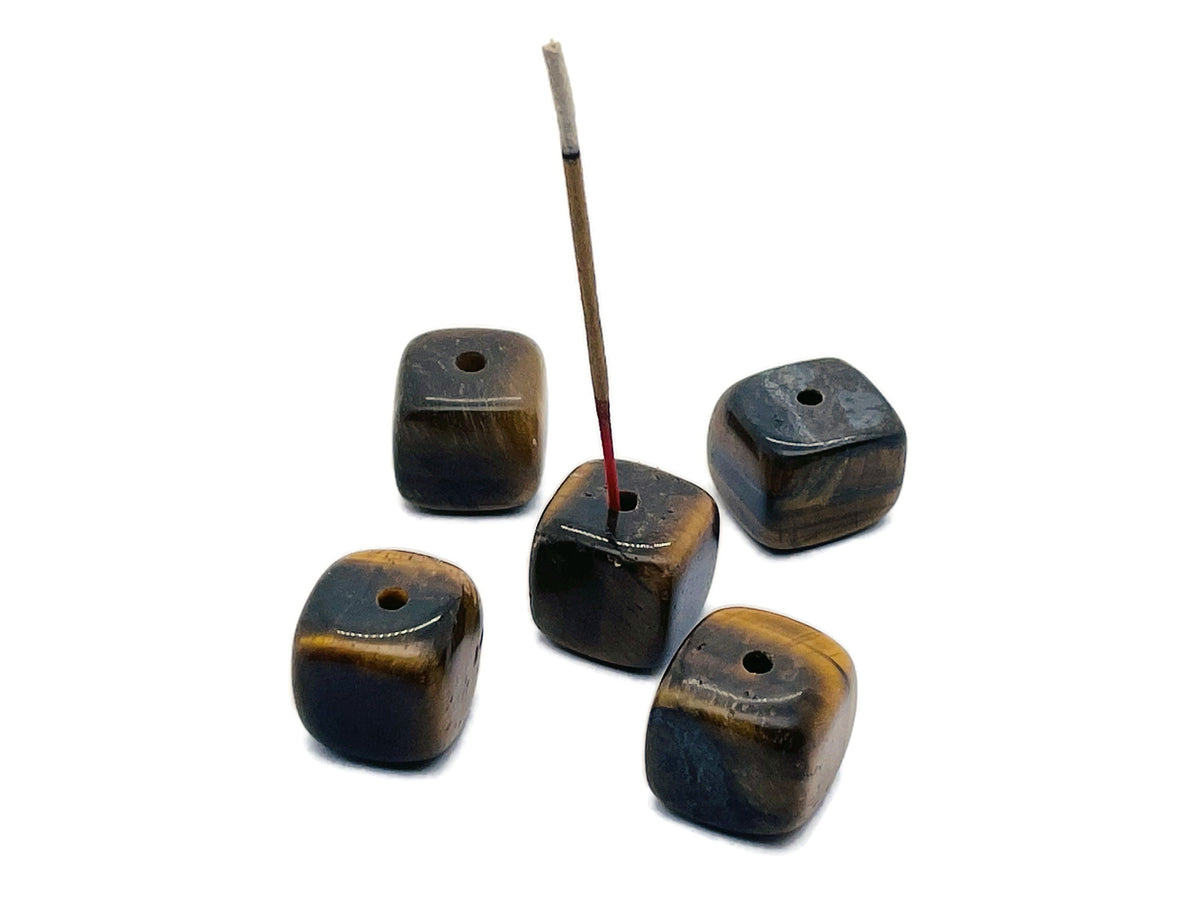 Handmade tiger eye crystal incense holder with carved design, gemstone stick holder for aromatic incense sticks.