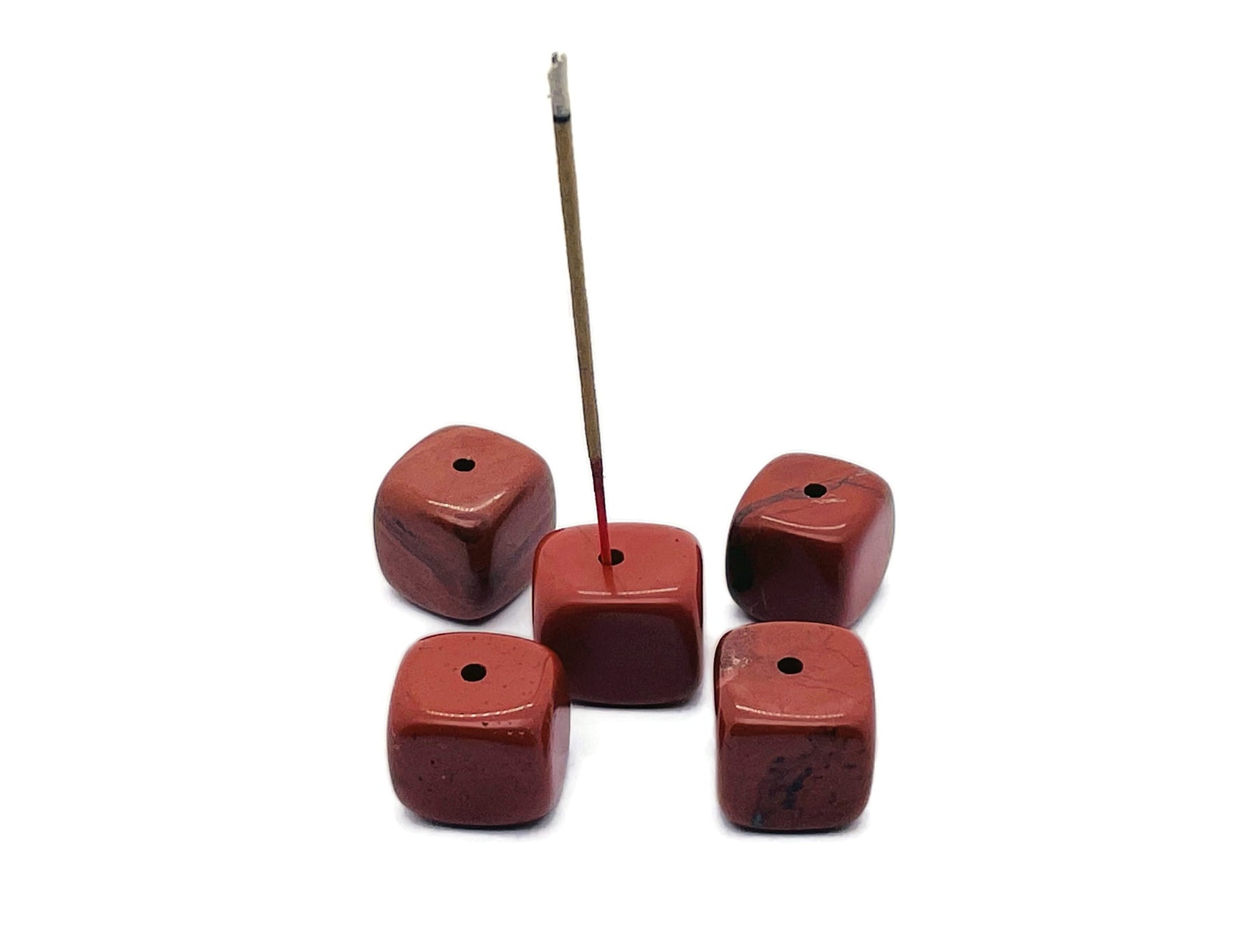 Red Jasper crystal incense holder with carved design, featuring a natural stone surface and space for incense sticks.