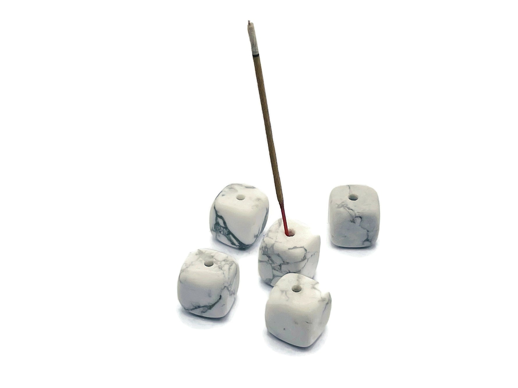 Handmade Howlite crystal incense holder with carved design, gemstone stick holder for incense sticks on a neutral background.