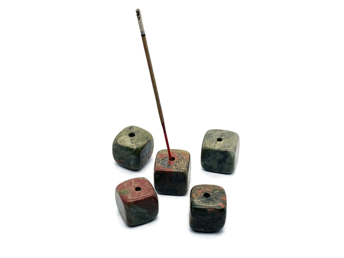Unakite crystal incense holder with carved design from GemstoneGO, perfect for holding incense sticks in a decorative stone display.
