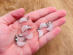 Rose quartz moon-shaped crystal pendant from GemstoneGO, ideal for jewelry making, showcasing a smooth, polished pink gemstone.