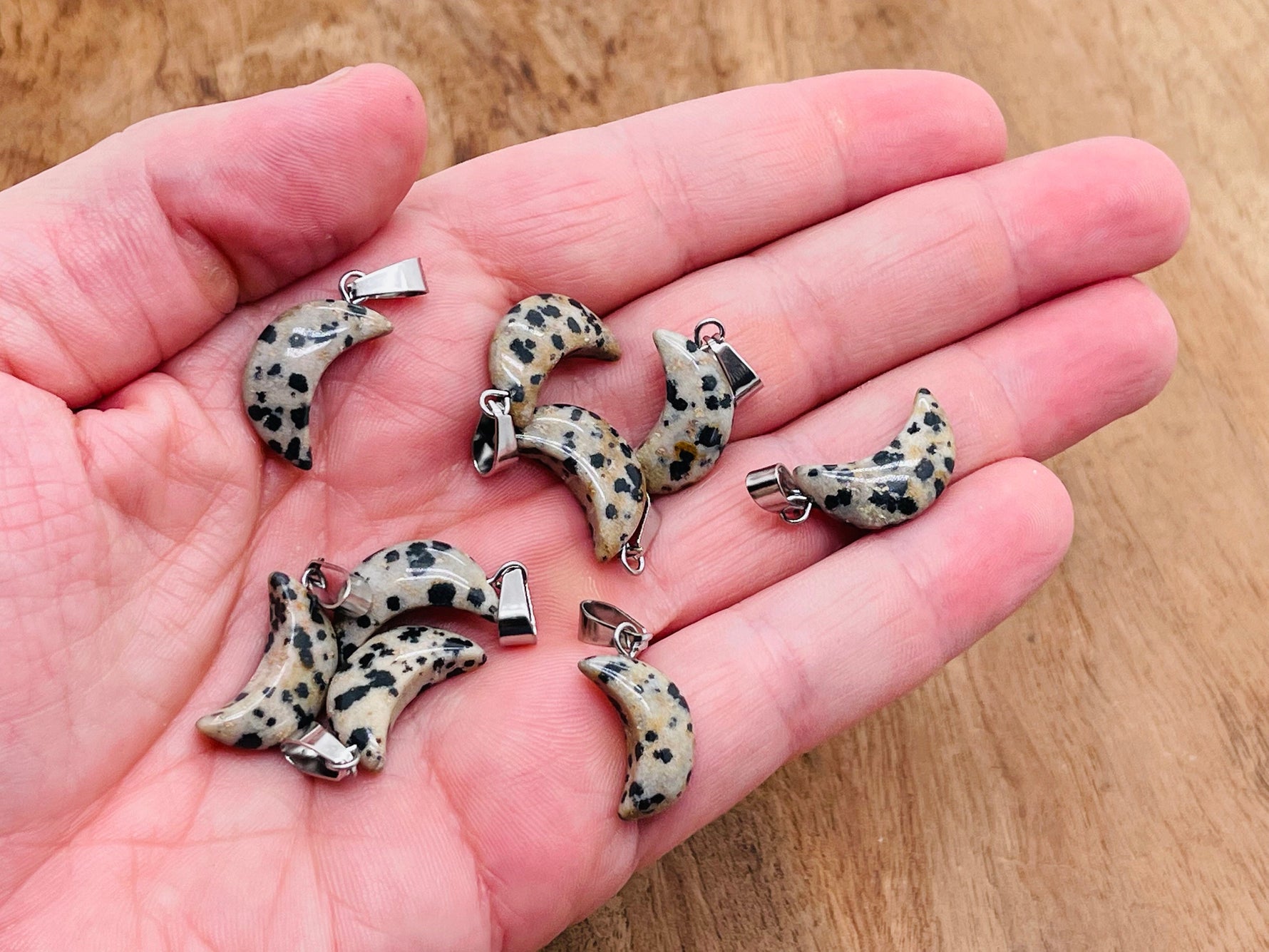 Dalmatian Jasper moon crystal pendant by GemstoneGO, showcasing a polished gemstone with distinctive black spots, ideal for jewelry making.