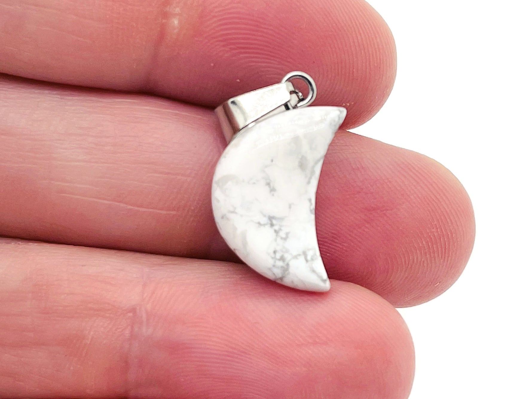 Howlite moon crystal pendant from GemstoneGO, featuring a smooth white gemstone in a moon shape, ideal for jewelry making.