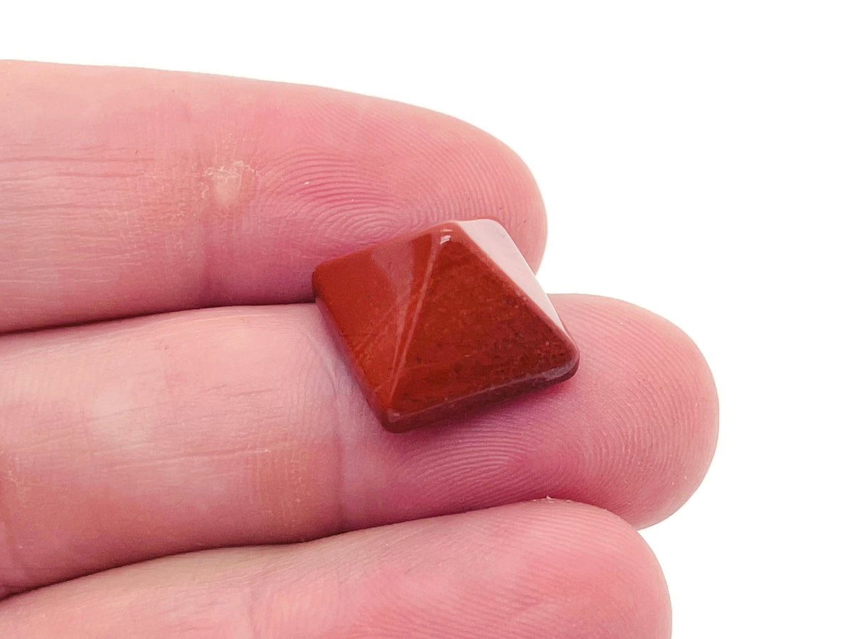 Red Jasper pyramid gemstone carving, 14mm size from GemstoneGO, featuring a polished red jasper with natural stone details.