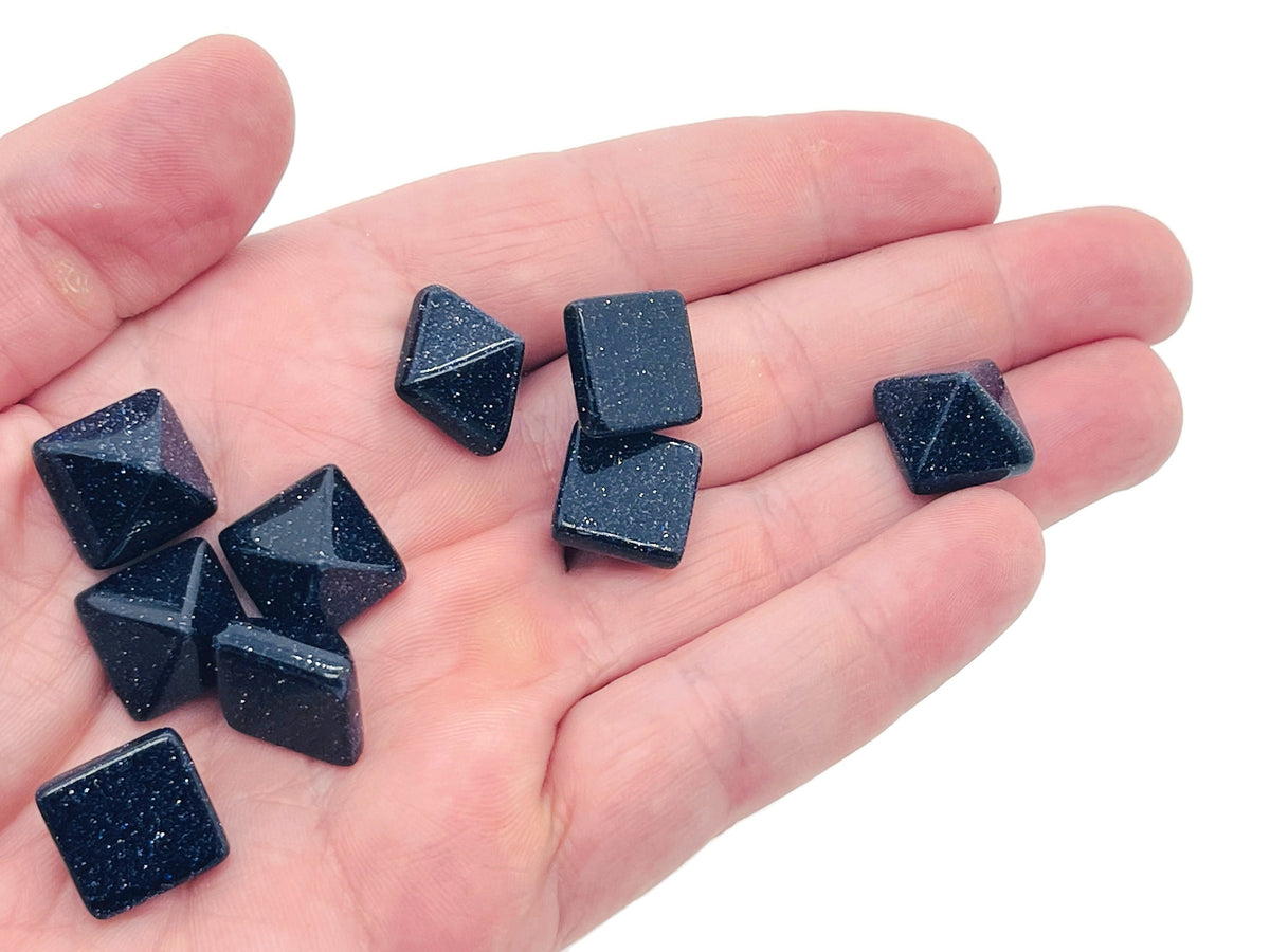 Blue Goldstone pyramid carving gemstone, 14mm, from GemstoneGO, showcasing a polished blue and gold speckled stone.