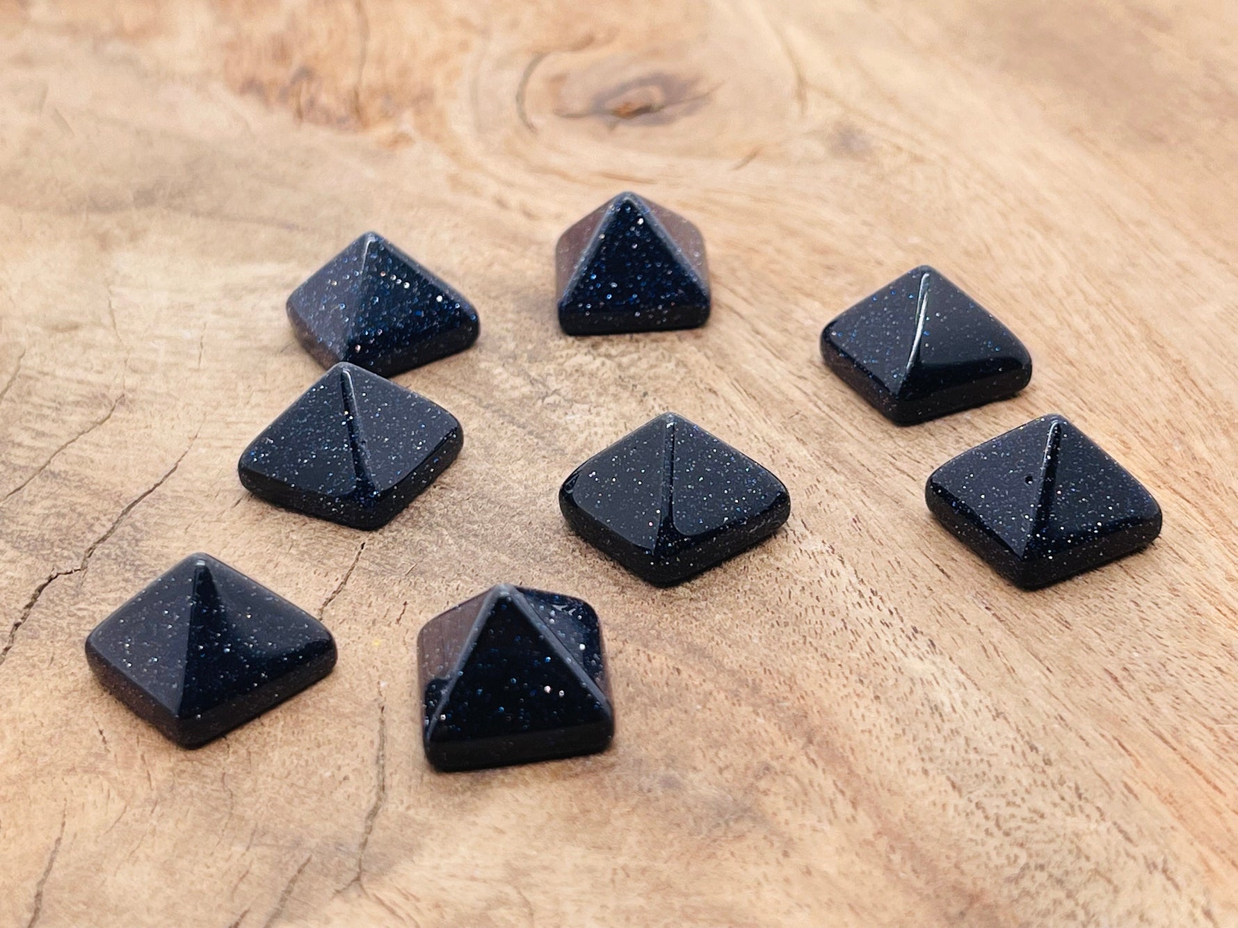 Blue Goldstone pyramid gemstone carving, 14mm, from GemstoneGO, featuring a polished, deep blue with gold flecks surface.