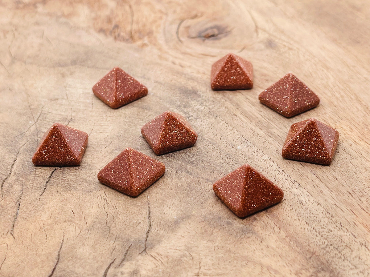 14mm Goldstone pyramid gemstone carving by GemstoneGO, showcasing a shimmering brown and gold-colored pyramid-shaped stone.