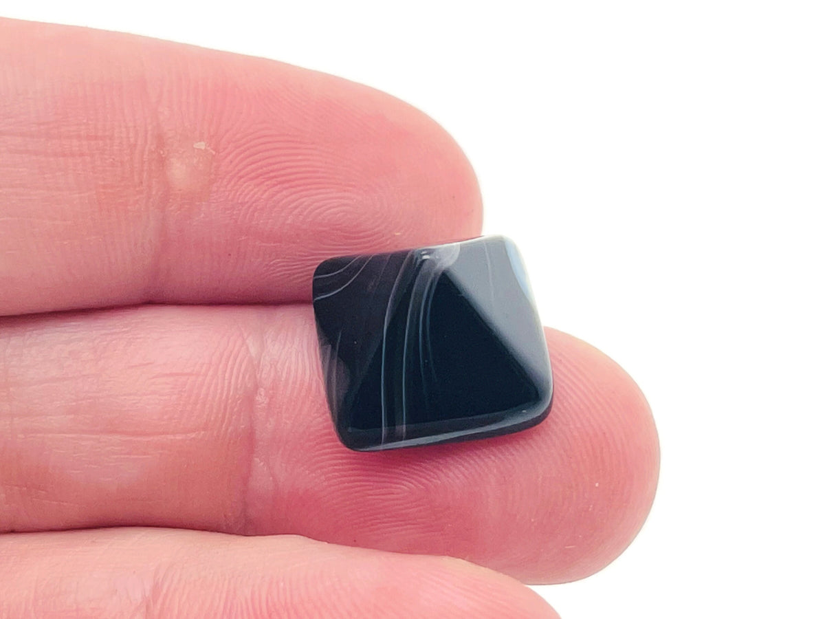 Black agate pyramid carving gemstone, 14mm, from GemstoneGO, showing a polished black stone with pyramid shape and detailed carvings.