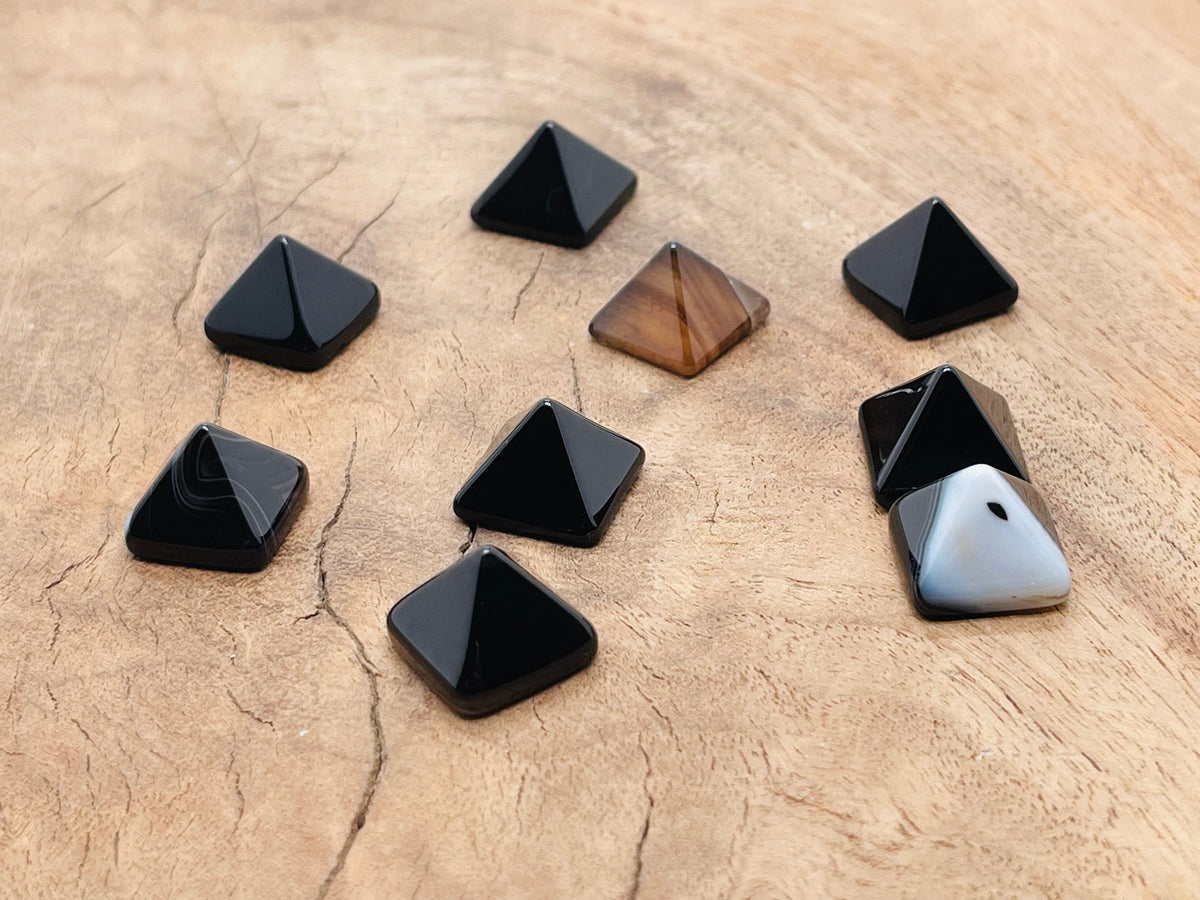 Black Agate pyramid gemstone carving, 14mm, from GemstoneGO, showing a polished black agate pyramid with natural banding and smooth facets.
